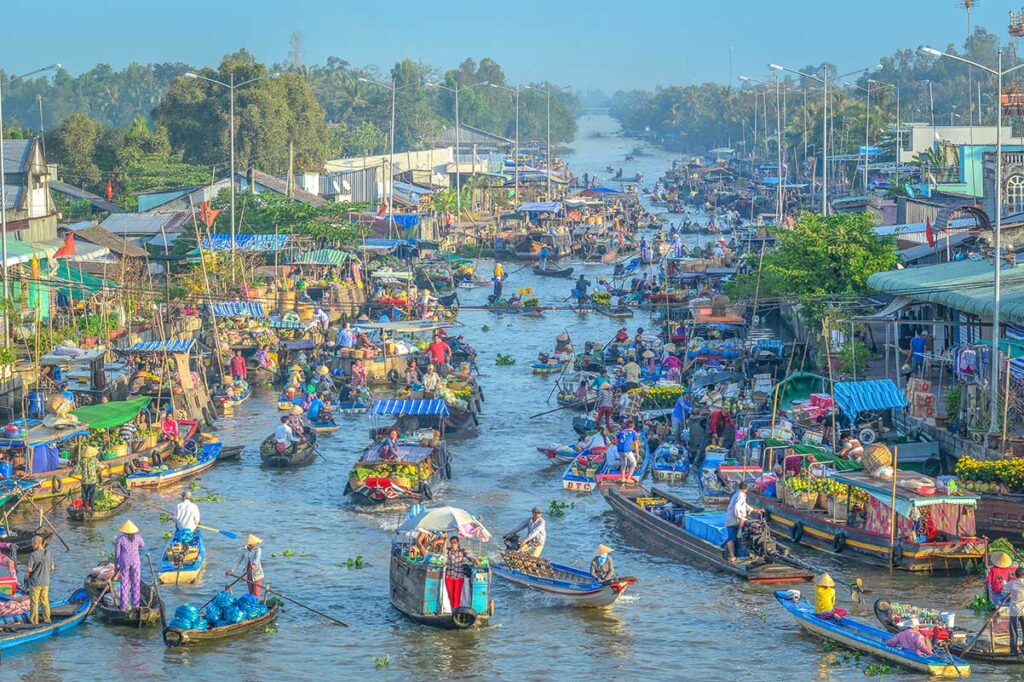 Early morning rush at Nga Nam Floating Market with boats tightly packed along the five-way canal intersection.