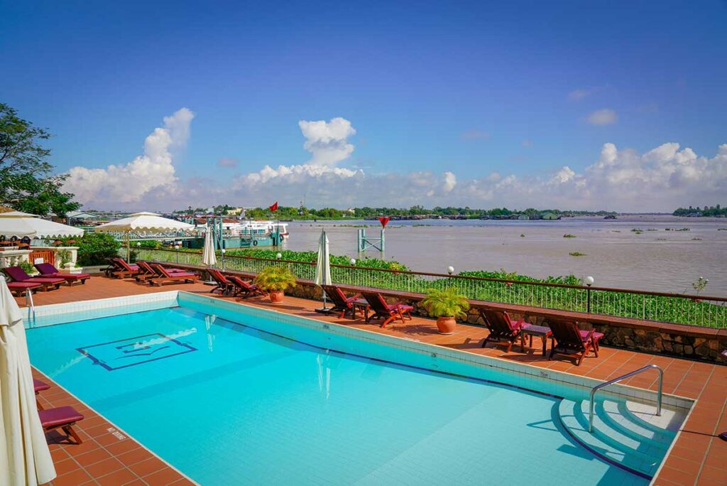 Riverside pool area at Victoria Chau Doc Hotel overlooking the Hau River, a popular upscale stay in the Mekong Delta.