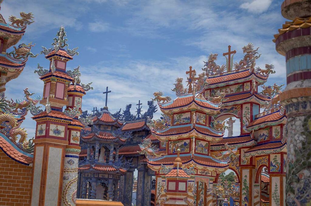 Pagoda-style towers and Christian crosses rise side by side at Hue’s An Bang Cemetery, illustrating the coexistence of multiple faiths in Vietnam’s “City of Ghosts.”