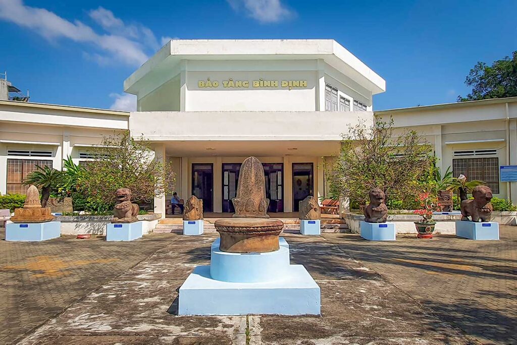 Entrance of Binh Dinh Museum in Quy Nhon with Cham stone sculptures on display.