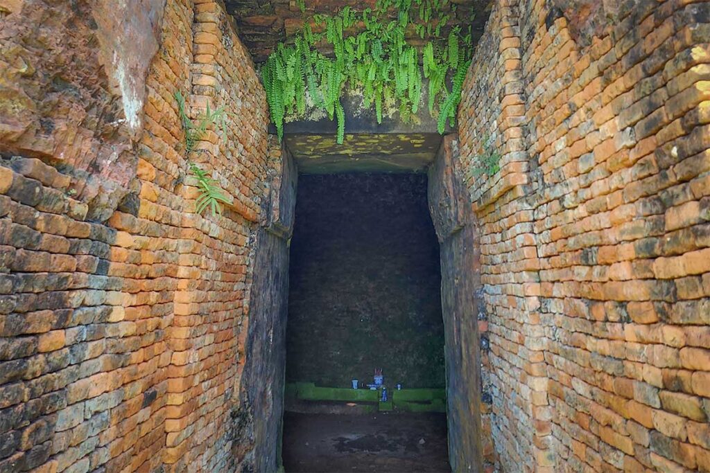 Inside the Chien Dan Cham Towers museum with sandstone carvings and architectural fragments from the Cham period displayed on simple pedestals.