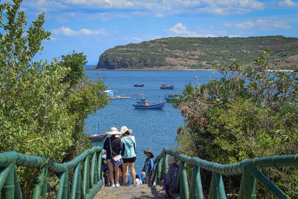 Path down to the fishing boats and coastal views near Da Dia Reef, Phu Yen Province, Vietnam.