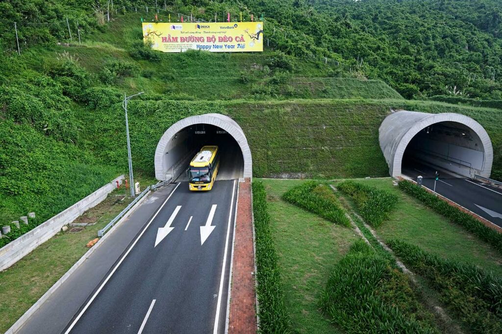 Deo Ca Tunnel entrance – Modern Deo Ca Tunnel entrance with a bus entering, providing a faster alternative to the old pass road between Phu Yen and Khanh Hoa.