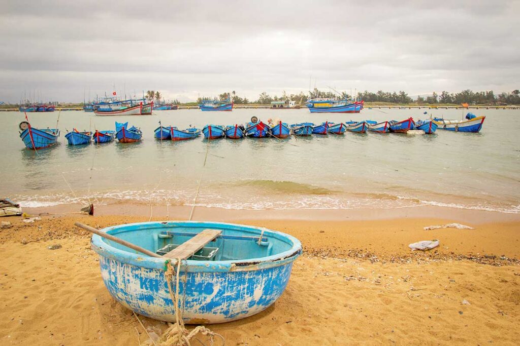 Fishing boats and round basket boats anchored at Dong Tac fishing port near Tuy Hoa, Phu Yen.