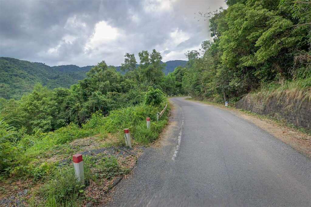 Winding scenic road through lush jungle inside Hon Ba Nature Reserve, a popular motorbike route from Nha Trang to the summit.