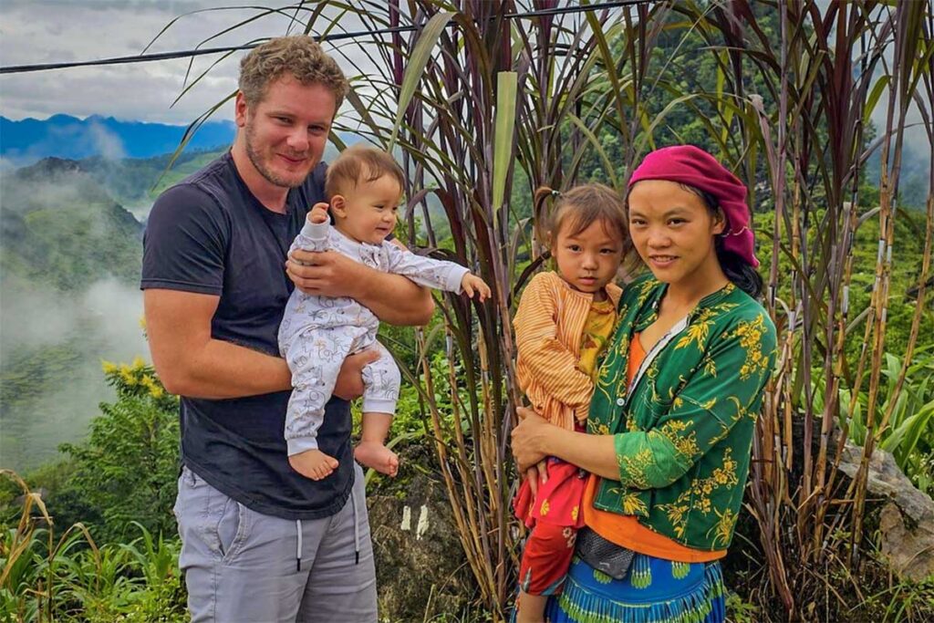 Marnick from Local Vietnam meeting local families in Ha Giang — showing the agency’s close relationships with ethnic communities and focus on meaningful local travel experiences.