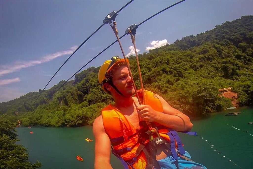 Marnick Schoonderwoerd from Local Vietnam ziplining over the river in Phong Nha-Ke Bang National Park, Vietnam