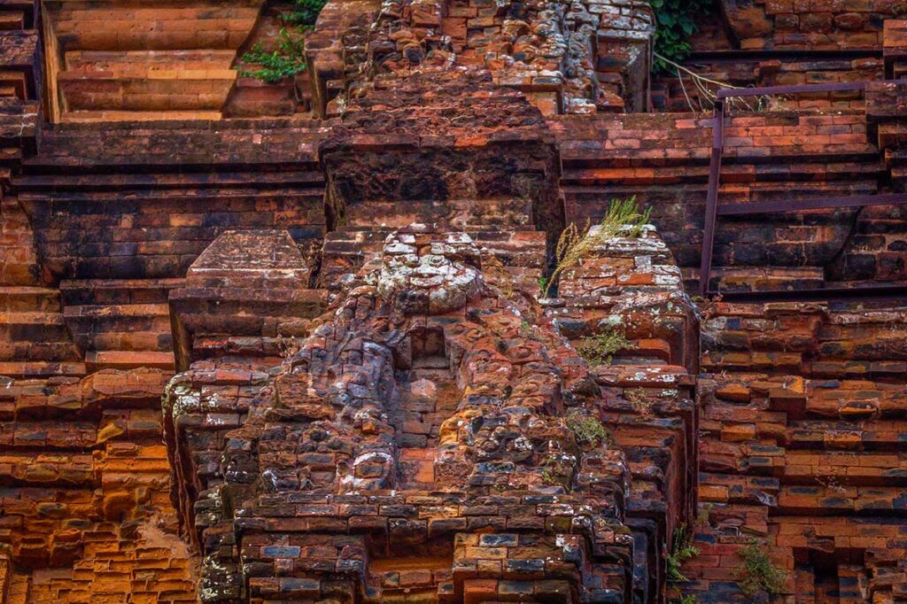 Detailed stone and brick carvings on the facade of Nhan Cham Tower in Tuy Hoa