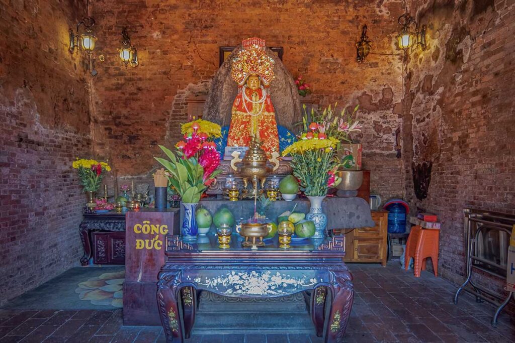 Interior shrine of Nhan Temple with incense altar and offerings in Tuy Hoa, Phu Yen