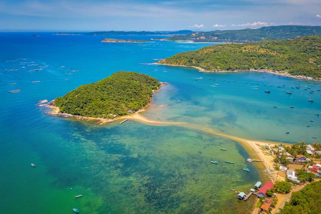Aerial view of Nhat Tu Son Island in Xuan Dai Bay, Phu Yen, connected to the mainland by a tidal sandbar at low tide.
