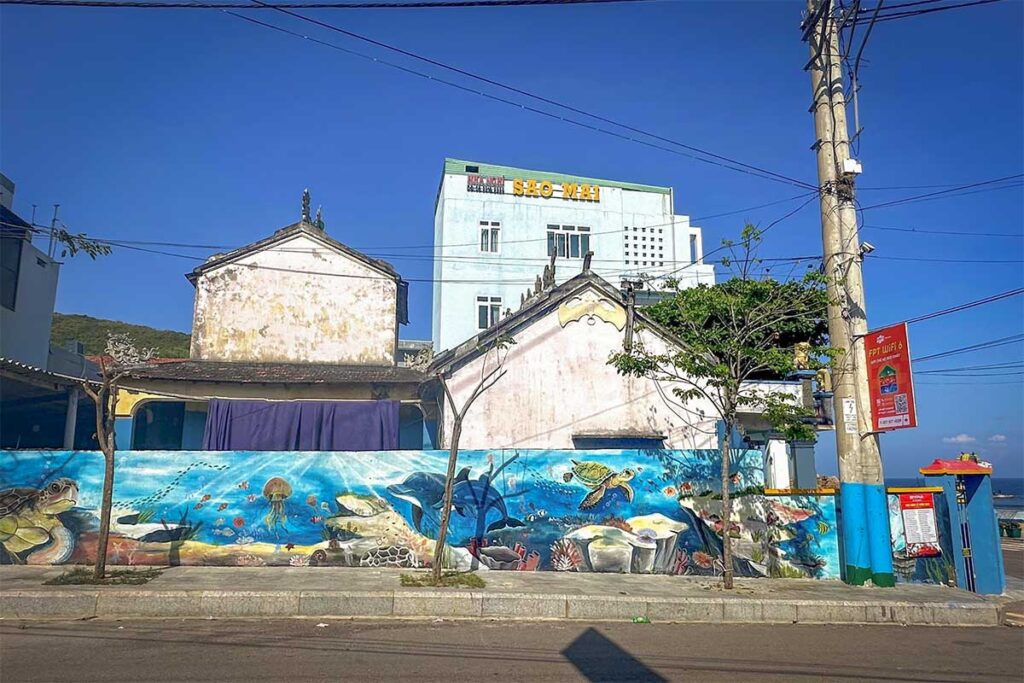 Street mural with ocean life in Nhon Hai – Community wall art with turtles, fish, and coral scenes, adding color to the fishing village streets.