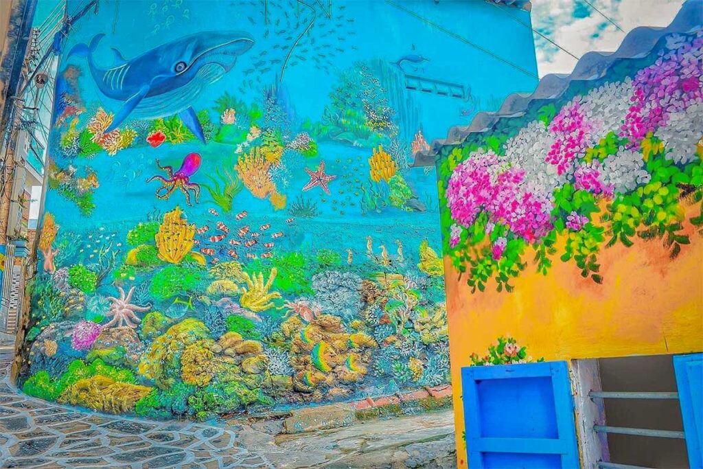 Colorful underwater mural along the blue-white alleys of Nhon Ly, a photogenic fishing village near Quy Nhon.