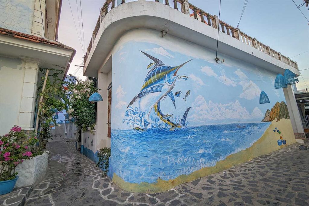 Sea-life mural (marlin) brightening a corner house on the stone lanes of Nhon Ly fishing village, Quy Nhon.