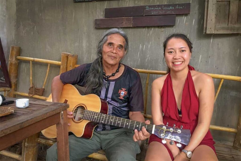 Nhung Phung from Local Vietnam meeting a local musician in a traditional village in Kon Tum, Vietnam