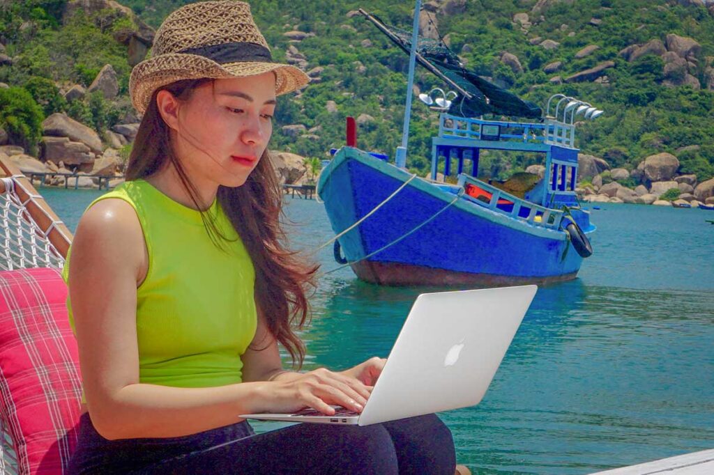 Nhung from Local Vietnam working remotely while exploring Vietnam’s coastline — symbolizing a modern local travel expert who personally designs customized tours across the country.