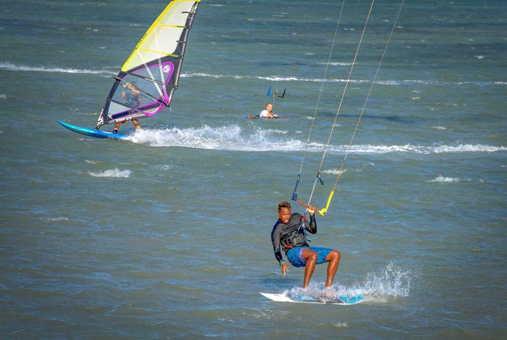 Kitesurfer gliding across the windy waters of Ninh Chu Beach, Phan Rang, a popular spot for water sports