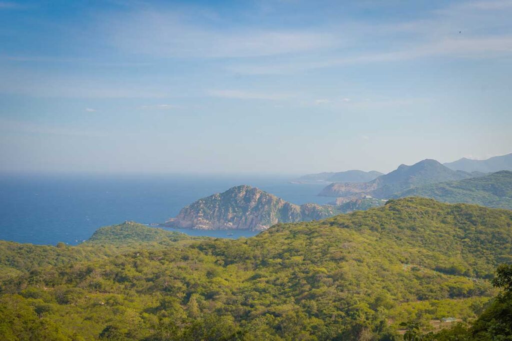 Scenic view over Nui Chua National Park’s green hills and rugged coastline near Phan Rang, showing the contrast of forest and sea.