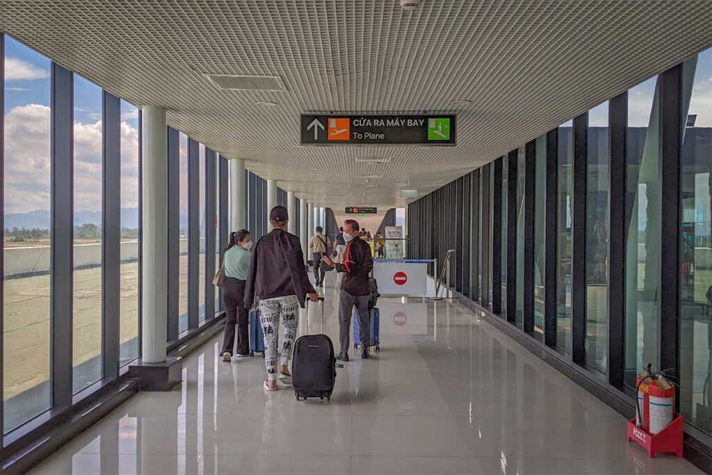 Passengers walking through the boarding corridor at Quy Nhon Airport (Phu Cat), heading to their direct flights to Hanoi or Ho Chi Minh City.