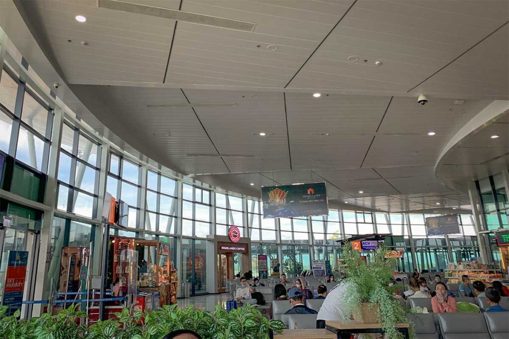 Departure hall at Quy Nhon Airport with waiting areas, check-in counters, and small shops for travelers.