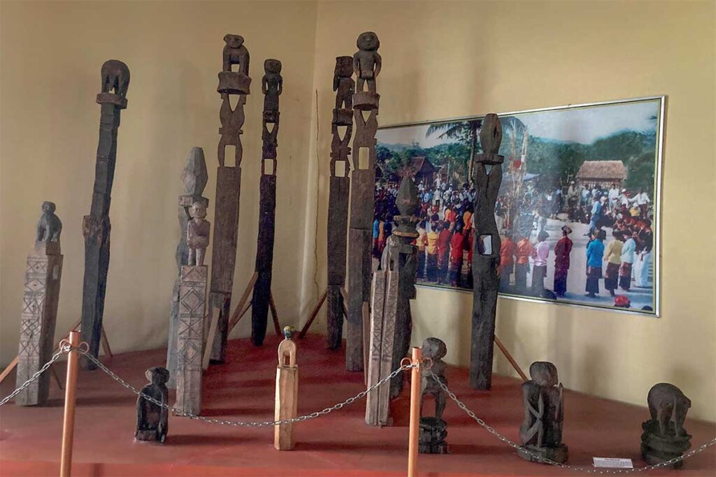 Display of carved wooden totems and ritual posts at Phu Yen Museum, reflecting ethnic traditions and Cham-influenced cultural heritage.