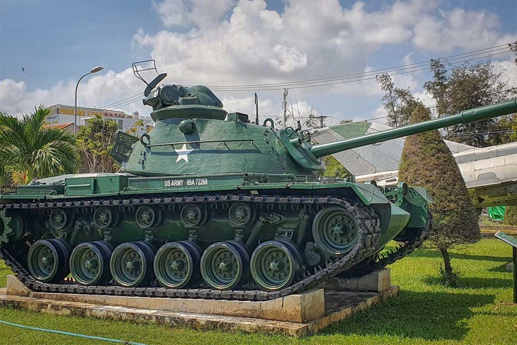 Green US Army tank on display in the outdoor yard of Phu Yen Museum, a remnant of Vietnam’s war history.