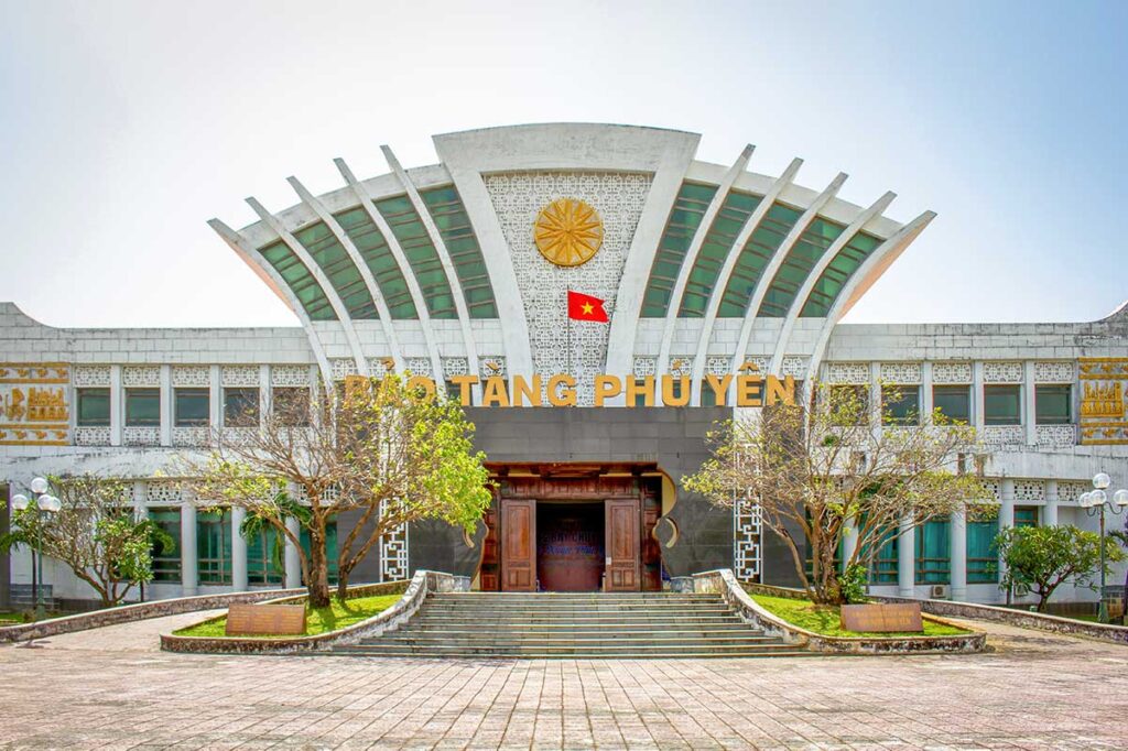 Front view of Phu Yen Museum in Tuy Hoa on a cloudy day, showing the modern provincial architecture and large courtyard.