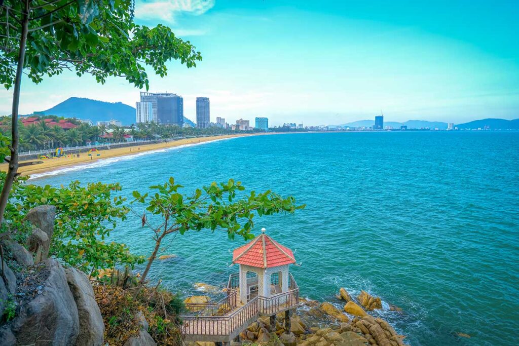 View from Queen’s Beach over Quy Nhon City Beach and promenade from a rocky pavilion lookout.