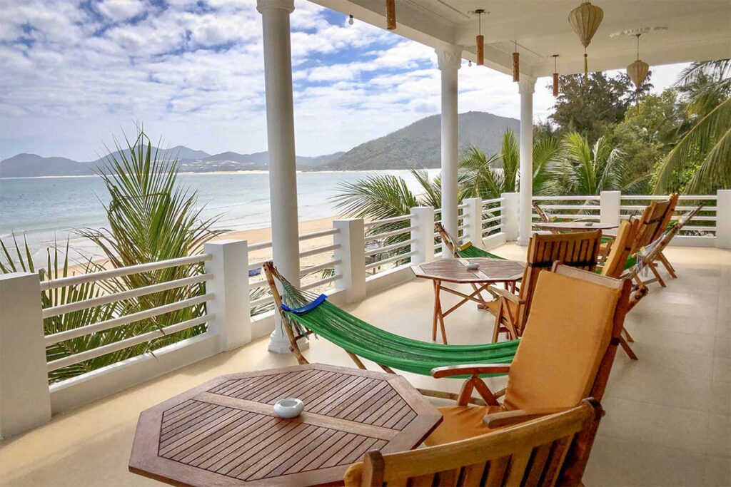 Timothe Beach Apartments, Vinh Hoa Beach — sea-view terrace with hammocks overlooking the bay.