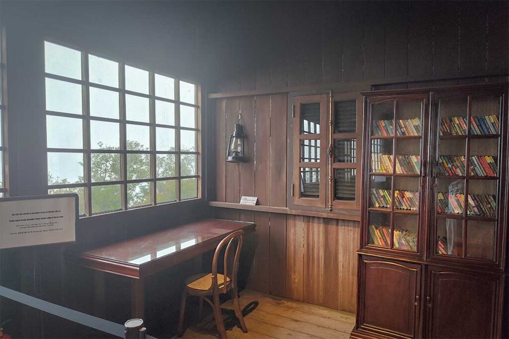 Inside Alexandre Yersin’s restored wooden house at the summit of Hon Ba Nature Reserve, featuring his study desk and book collection.