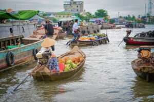 Traditional wooden boats at the Cai Rang Floating Market in the Mekong Delta — a highlight of our 1-week Vietnam tour covering Ho Chi Minh City, the Mekong, and Phu Quoc.