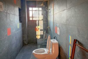 Bathroom of the Grand Suite at Ha Giang Aya Lodge with walk-in shower and stone tile walls.