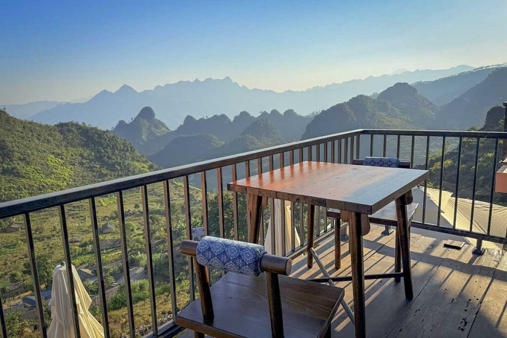 Balcony table overlooking limestone mountains and valleys at Ha Giang Aya Lodge.
