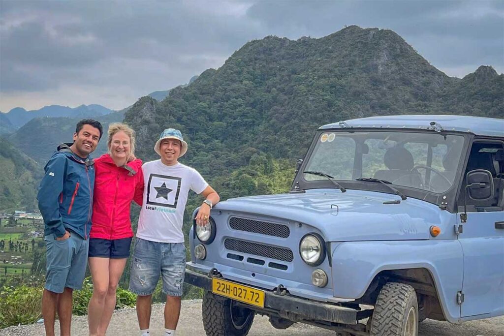 Local Vietnam driver with travelers on the Ha Giang Loop, one of Vietnam’s most scenic routes — available through customized car hire with driver.
