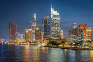 Evening skyline of Ho Chi Minh City with modern skyscrapers along the Saigon River — a vibrant finale to many Vietnam tours from north to south.