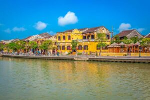 Yellow heritage houses reflected in the Thu Bon River in Hoi An — a favorite destination on many cultural Vietnam tours.