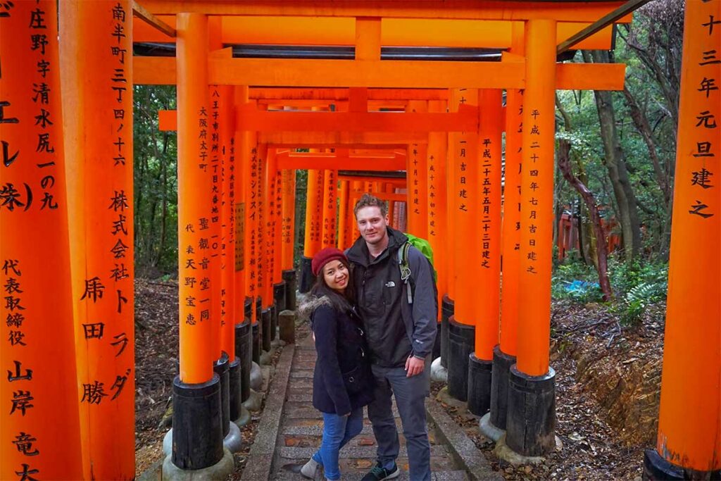 Nhung Phung and Marnick Schoonderwoerd visiting the Fushimi Inari Shrine in Kyoto, Japan — founders of Local Vietnam who combine international travel experience with deep local insight to design authentic Vietnam tours.