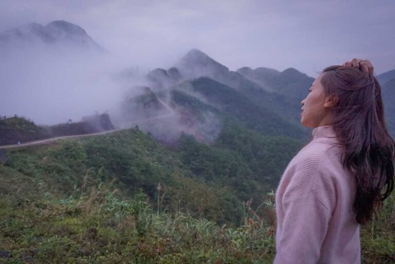 Vietnam travel expert Nhung Phung admiring the misty mountain views of Binh Lieu District near the Chinese border — a hidden gem known for its quiet, untouched beauty.