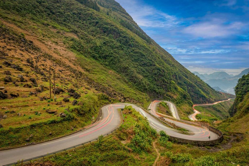 Winding mountain road on the Ha Giang Loop, one of the most scenic routes in Northern Vietnam tours and motorbike adventures.