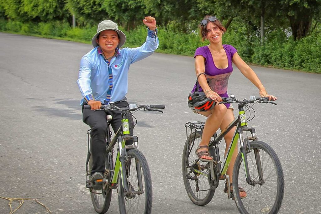 Vietnam tour guide leading a private cycling tour through the countryside — guided outdoor adventure in Vietnam.