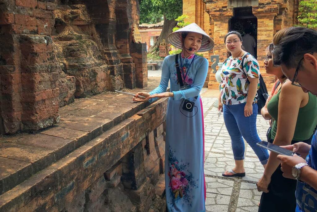 Vietnam tour guide explaining Cham temple history during a private cultural tour in Central Vietnam.