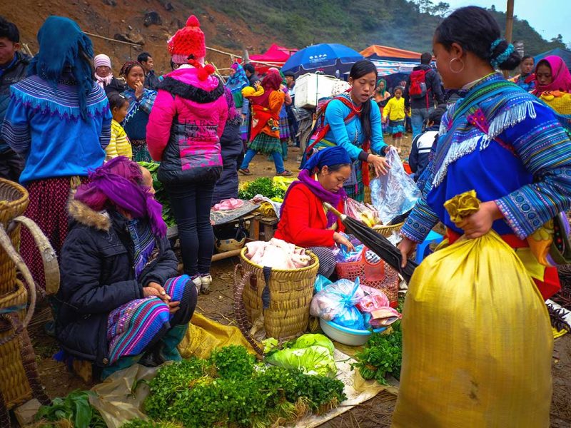can cau market 1 colorful minority woman shopping food at the Can Cau Market
