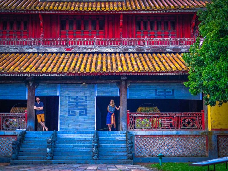 A couple standing in the door opening of a historical building inside Hue Imperial Citadel