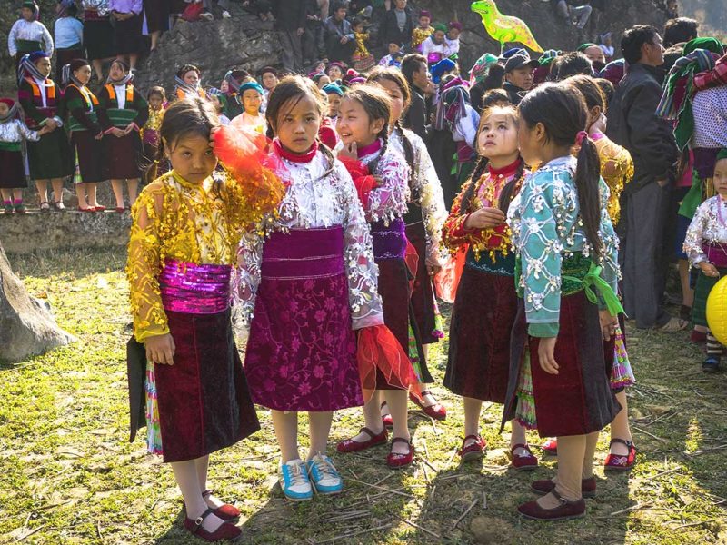 ha giang festival 1 A group of ethnic children dressed in vibrant, shining traditional clothes, celebrating a festival in Ha Giang.