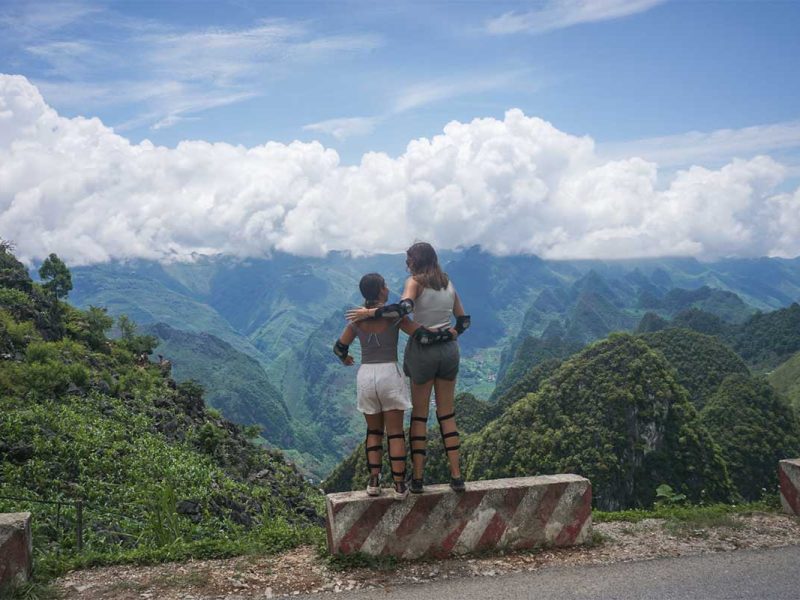 ha giang loop easy rider tour motorbike 13 Two women in motorbike gear posing with mountain views during Ha Giang motorbike tour