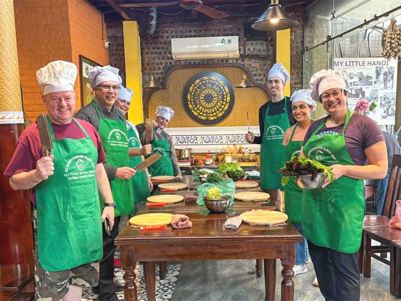 hanoi cooking class 1 Group of travelers gathered around a table, ready to start a cooking class in Hanoi