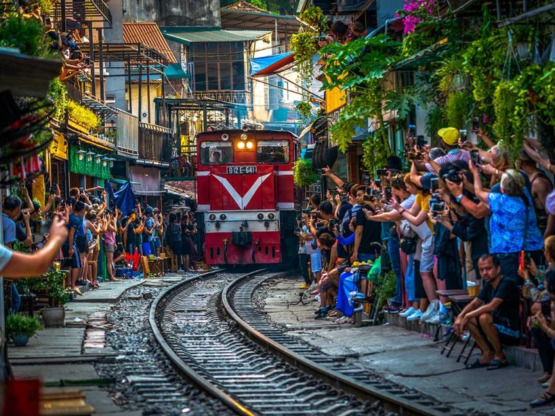 hanoi train street 4 Hanoi Train Street with lots of tourists making photos of the incoming train through a narrow street with train track