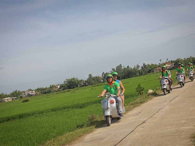 hoi an motorbike tour by vespa 3 Vintage Vespa crossing a traditional bamboo bridge during a Hoi An countryside tour