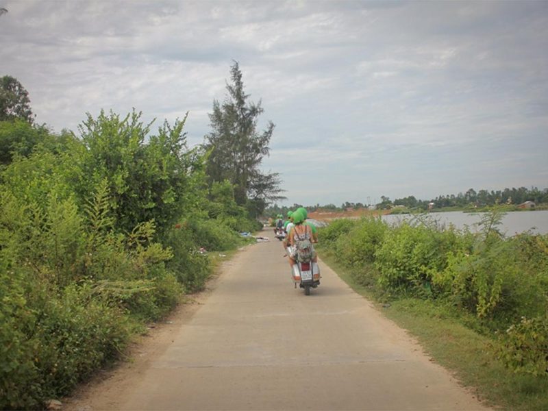 hoi an motorbike tour by vespa 9 Hoi An Vespa countryside tour following a quiet concrete road beside river canals