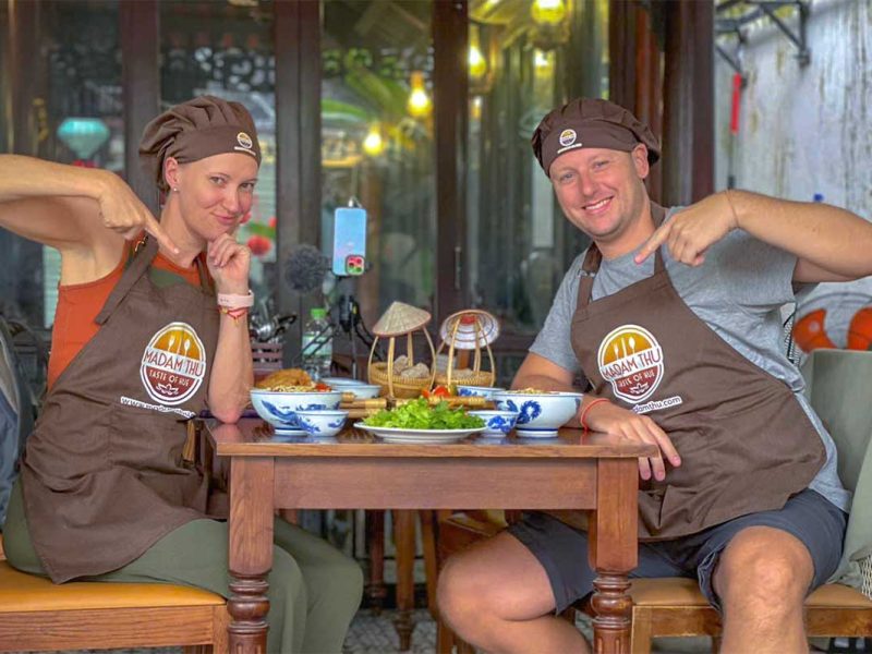 hue cooking class 1 Two tourists in aprons doing a Hue cooking class