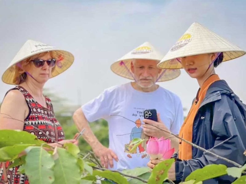 hue countryside tour 3 Travelers discovering lotus flowers with a local guide during a Hue countryside tour.